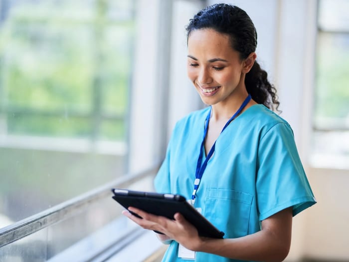 Healthcare professional working at a computer in a modern medical facility